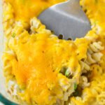 A large glass baking dish with a spatula scooping some Tuna Casserole.