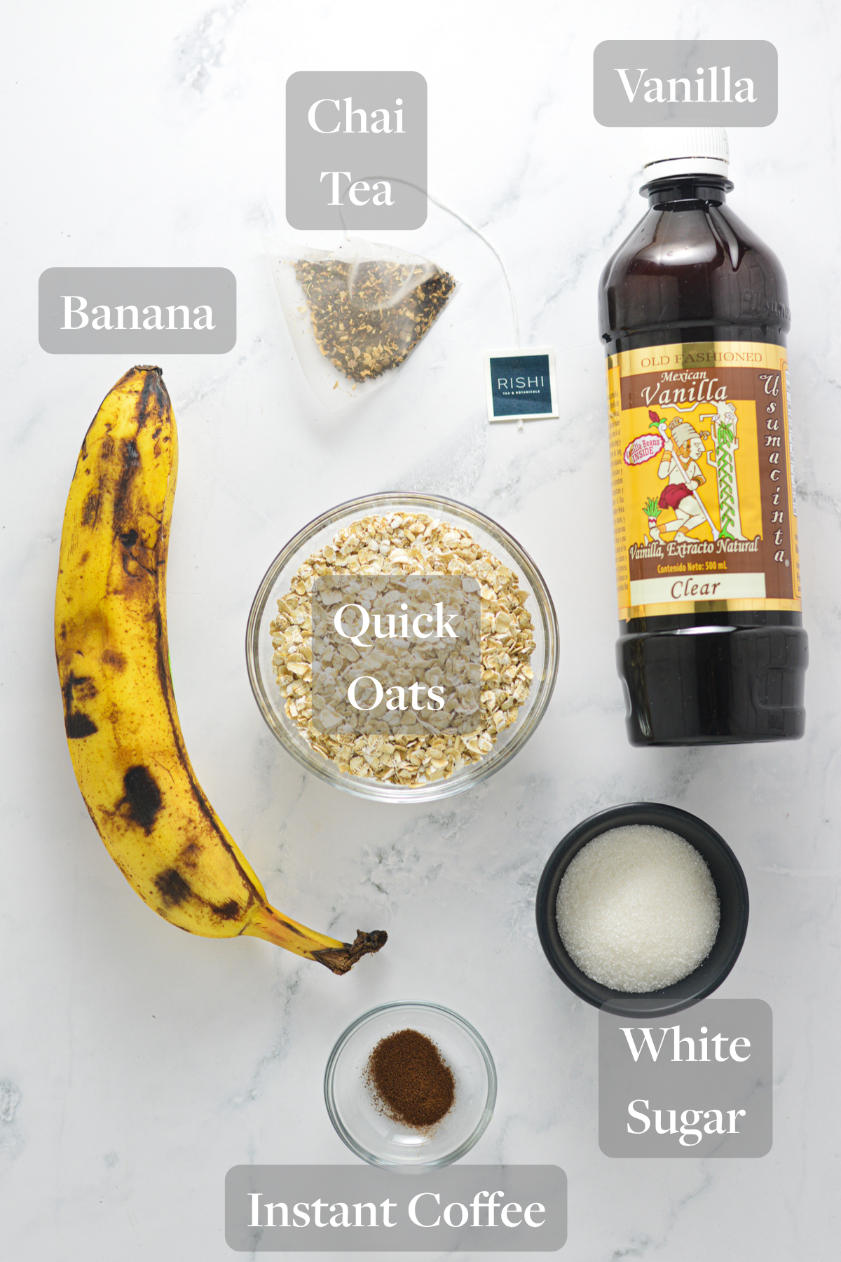 All the ingredients you need to make Eggless Banana Chai Latte Cookies laid out on a marble surface.