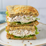 A Chicken Salad Sandwich cut in half, showing the toasted bread stuffed with creamy chicken salad.