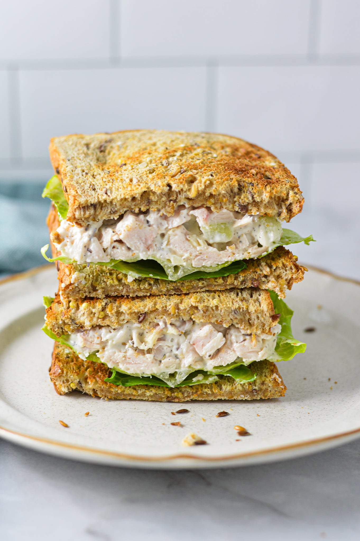 A Chicken Salad Sandwich cut in half, showing the toasted bread stuffed with creamy chicken salad.