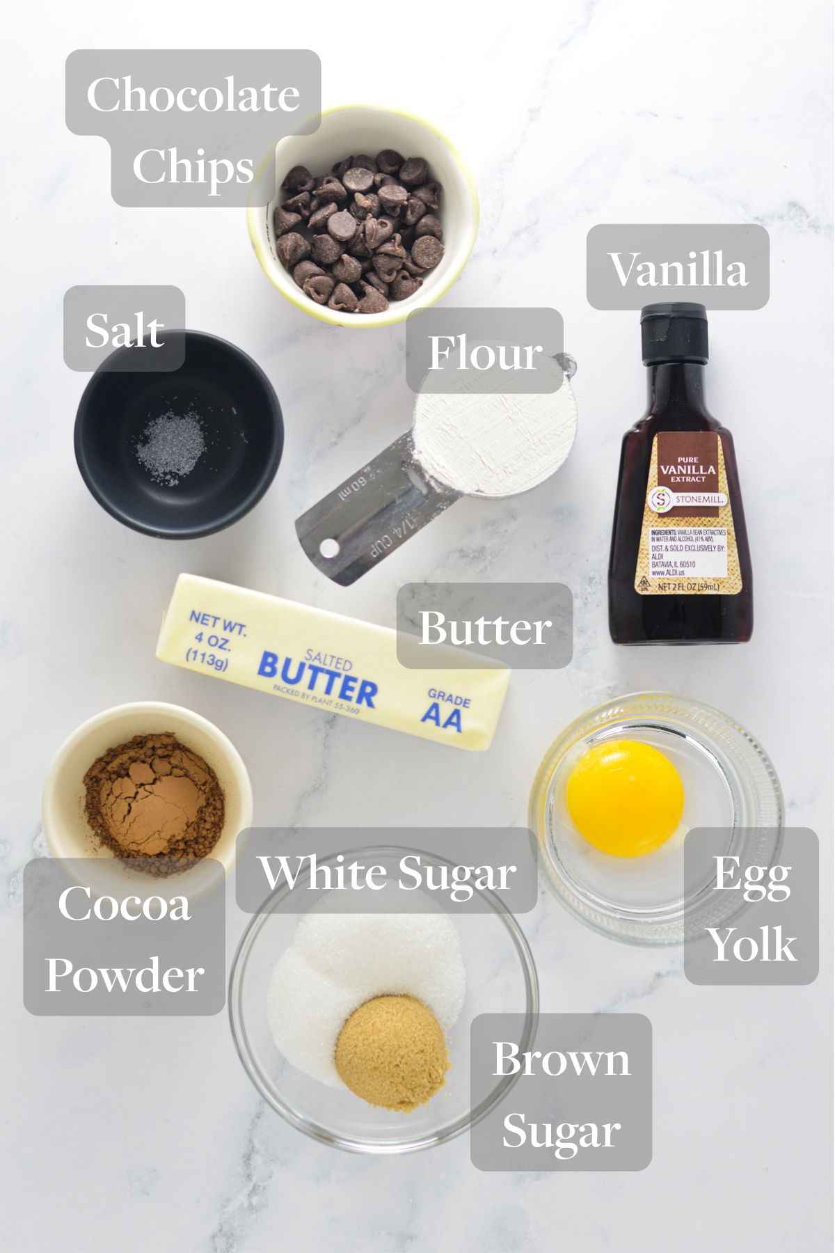All the ingredients you need to make a Microwave Brownie in a Cup laid out on a marble surface.