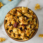 A bowl full of large clusters of homemade Sweet and Salty Coconut Vanilla Bean Granola.