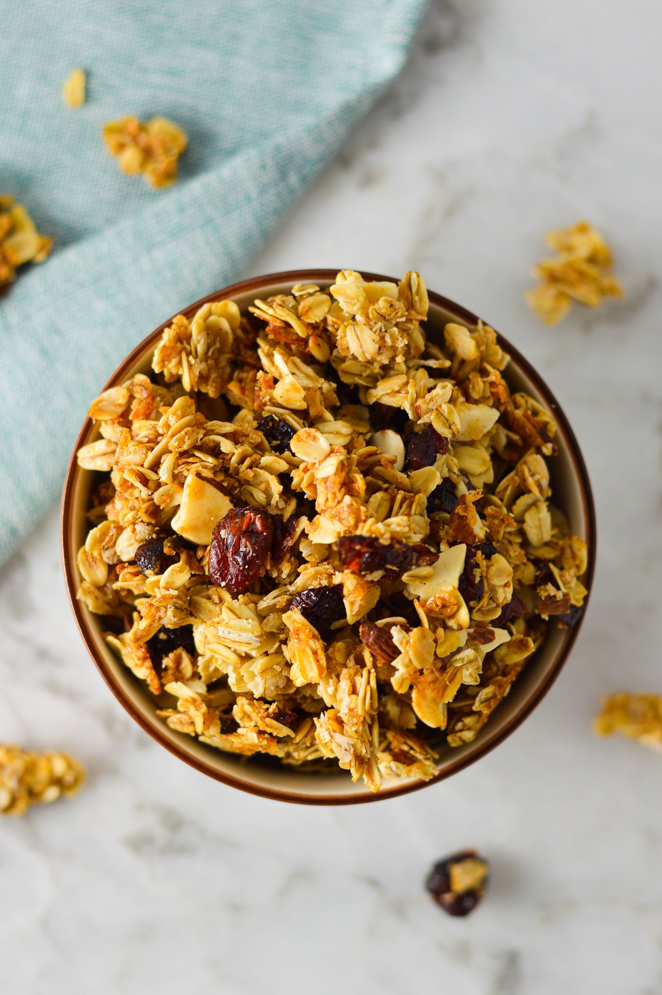 A bowl full of large clusters of homemade Sweet and Salty Coconut Vanilla Bean Granola.