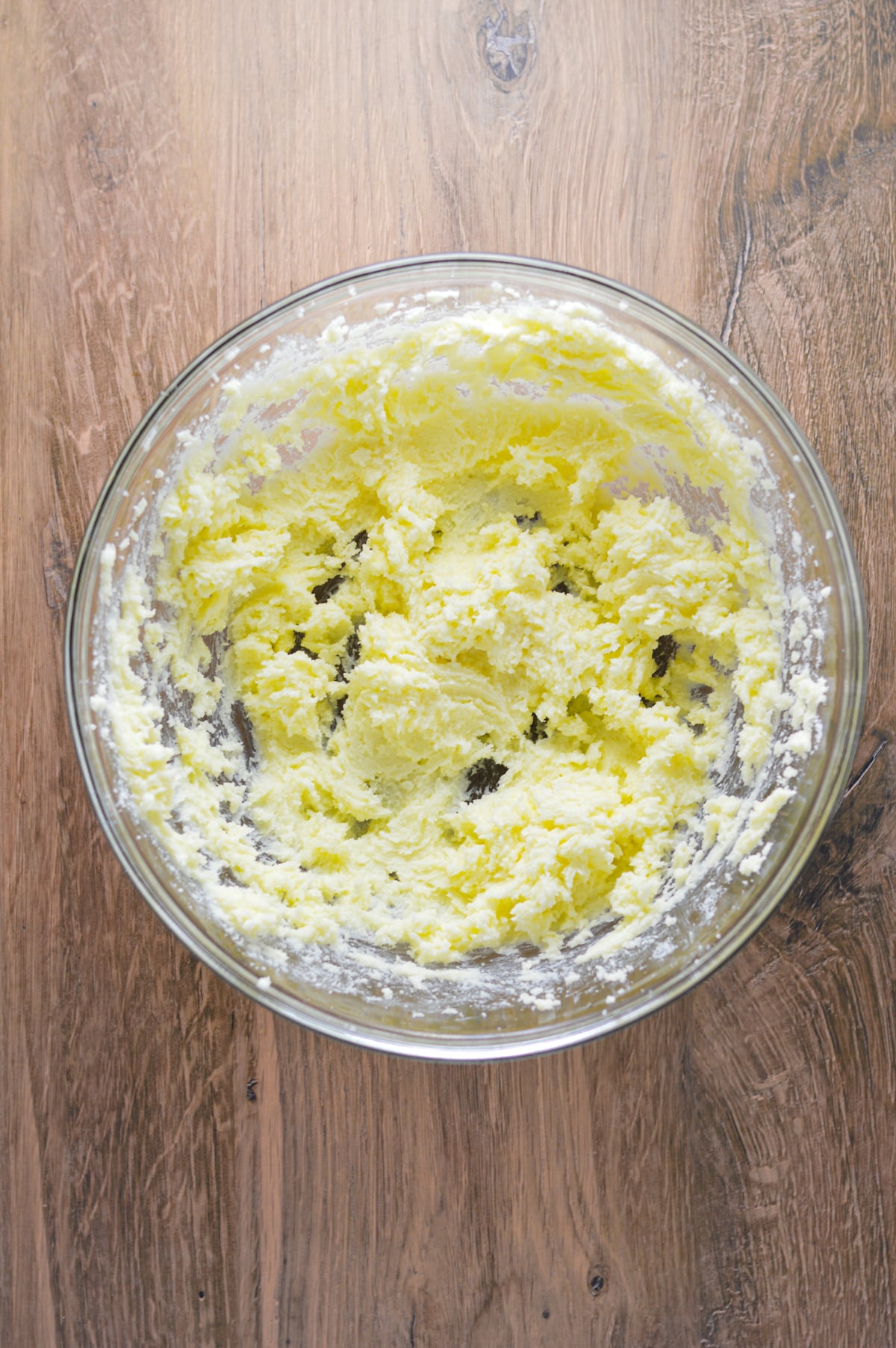 Some salted butter and white sugar creamed together in a large bowl.