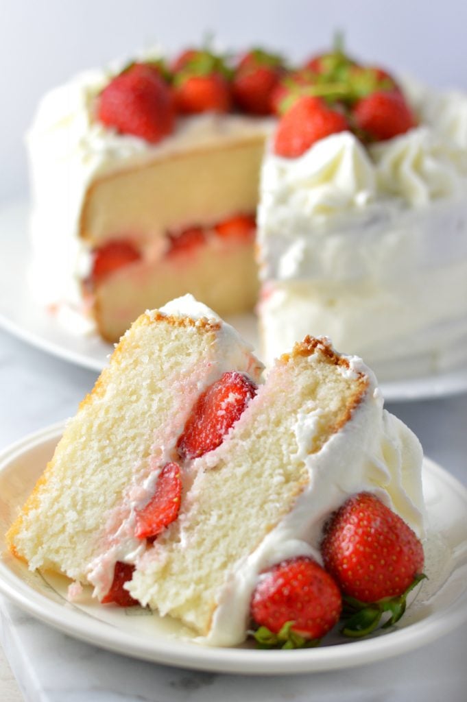 Easy strawberry layer cake recipe made from scratch! White cake with buttercream frosting, this is perfect for Canada Day, Valentine's Day or any other special occasion.