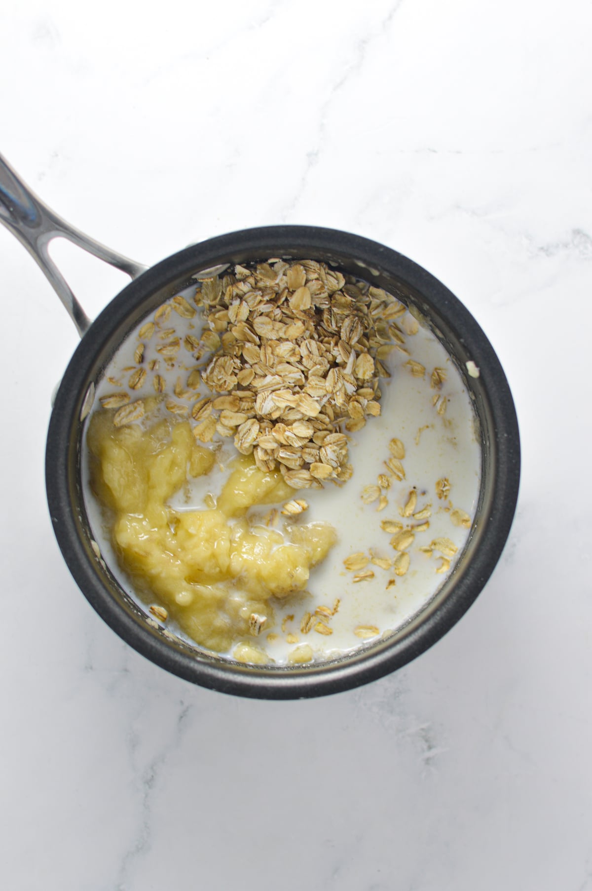 Banana, rolled oats and milk in a small saucepan.