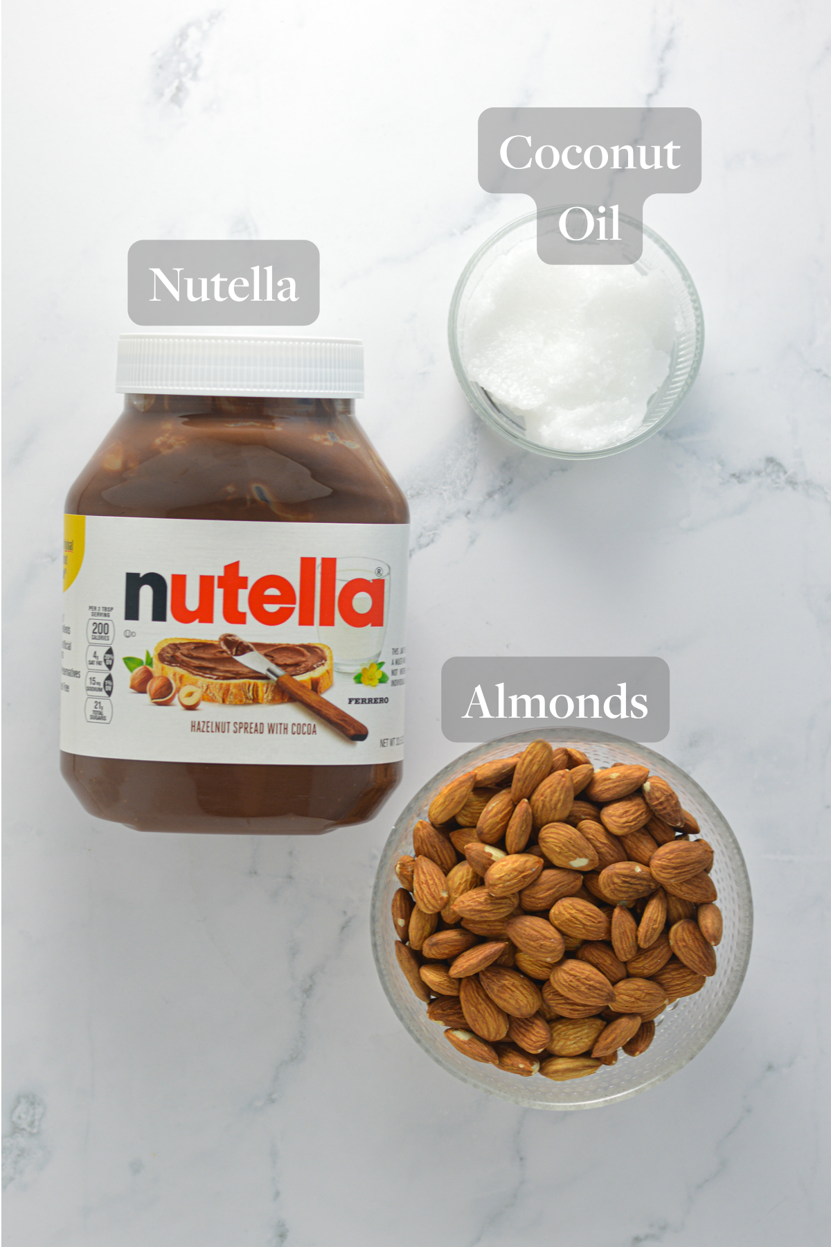 All the ingredients you need to make Almond Mini Nutella Cups laid out on a granite surface.