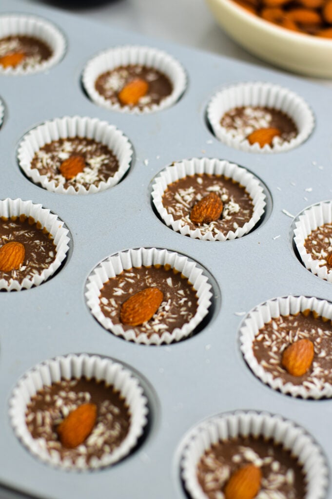 Side view of a mini muffin tin with Almond Coconut Nutella Cups.