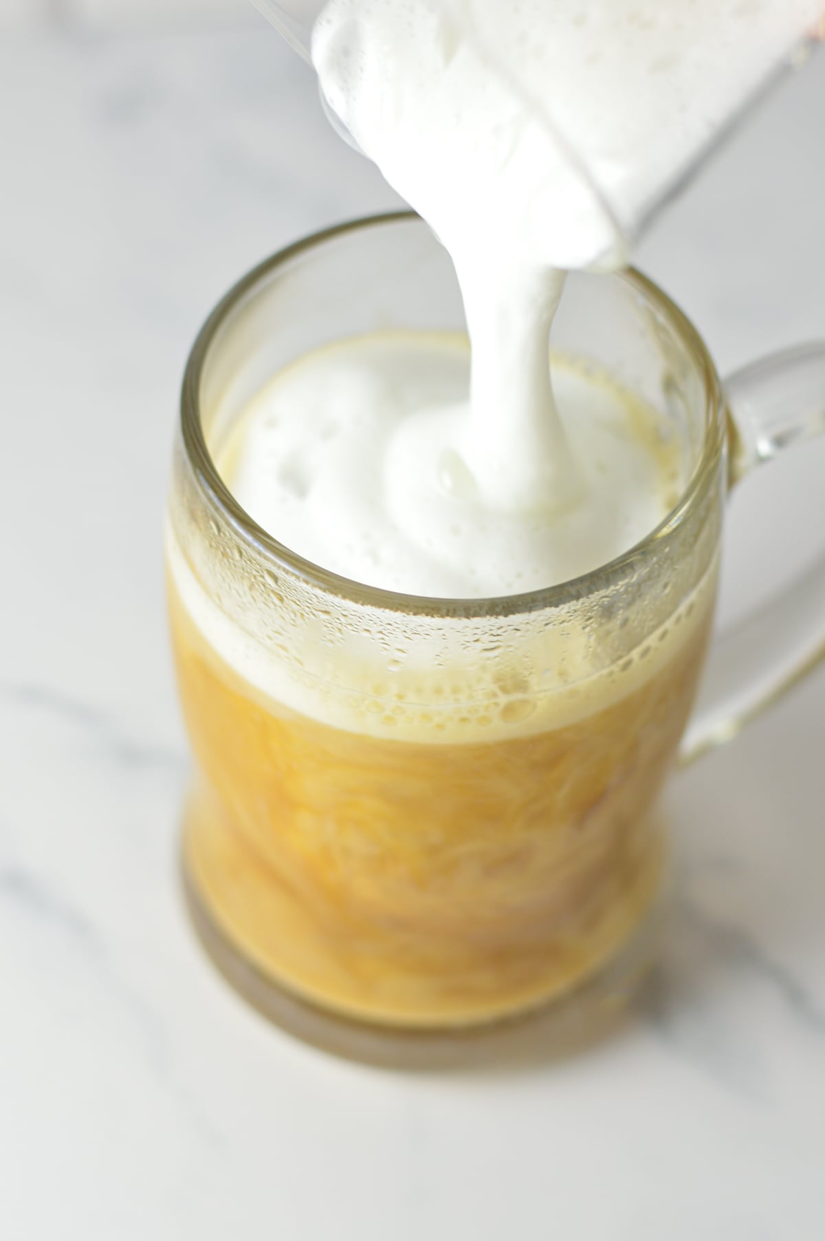 Foamy milk being poured into a Maple Latte.