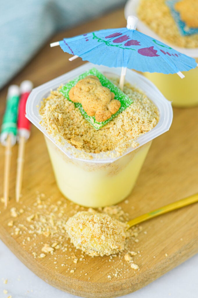 Sand Pudding Cups with a scoop of the pudding on a small gold spoon.