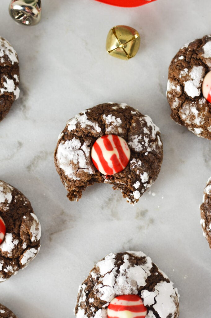 Peppermint Kiss Chocolate Crinkle Cookies with candy cane kisses on top of rich chocolate snowball cookies.