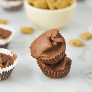 A stack of Chex Mini Nutella Cups, with some Chex cereal in a small bowl in the background.