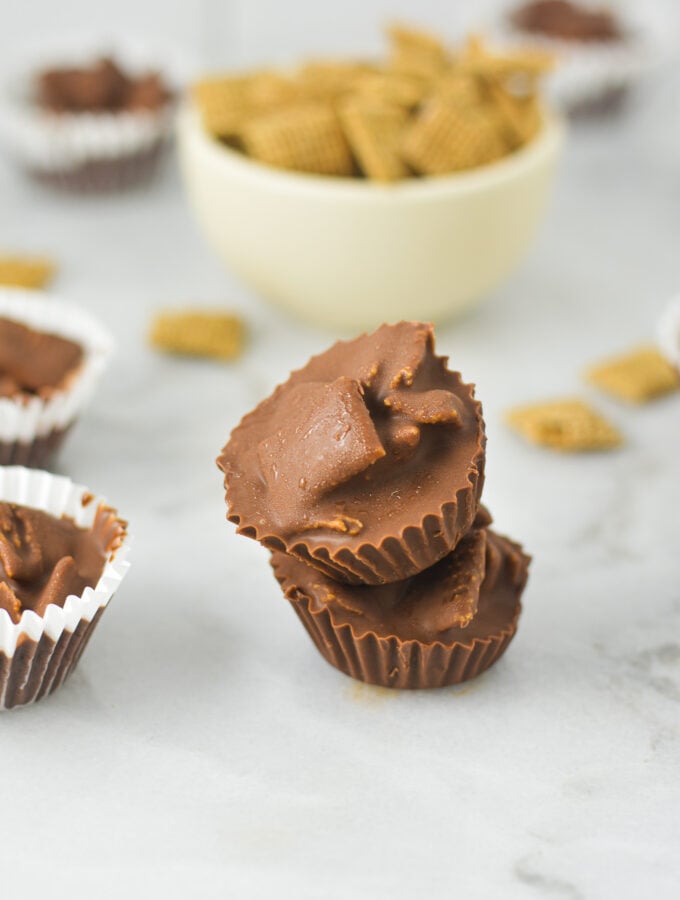 A stack of Chex Mini Nutella Cups, with some Chex cereal in a small bowl in the background.