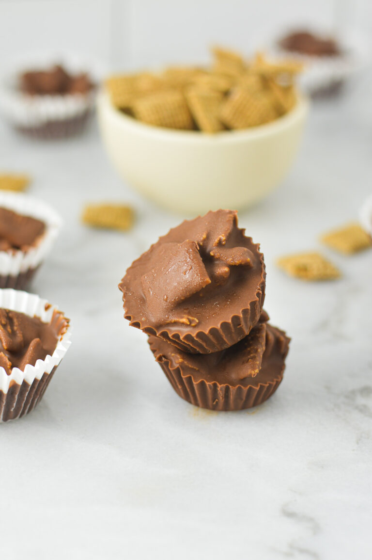 A stack of Chex Mini Nutella Cups, with some Chex cereal in a small bowl in the background.
