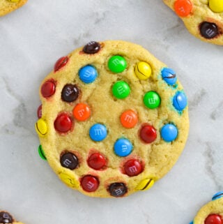 Some Mini M&M Cookies on a granite surface.