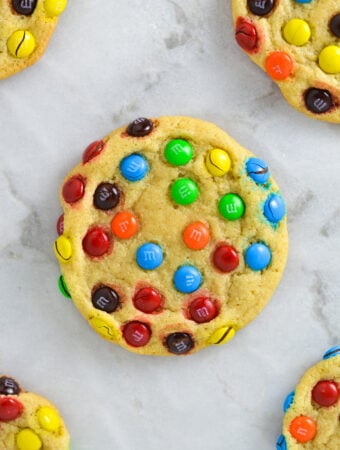 Some Mini M&M Cookies on a granite surface.