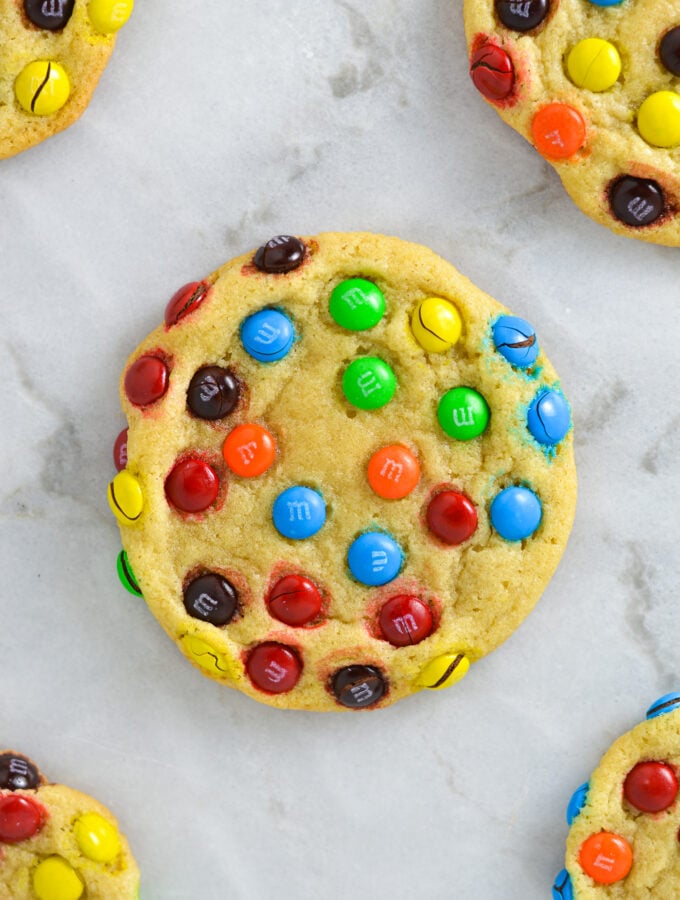 Some Mini M&M Cookies on a granite surface.