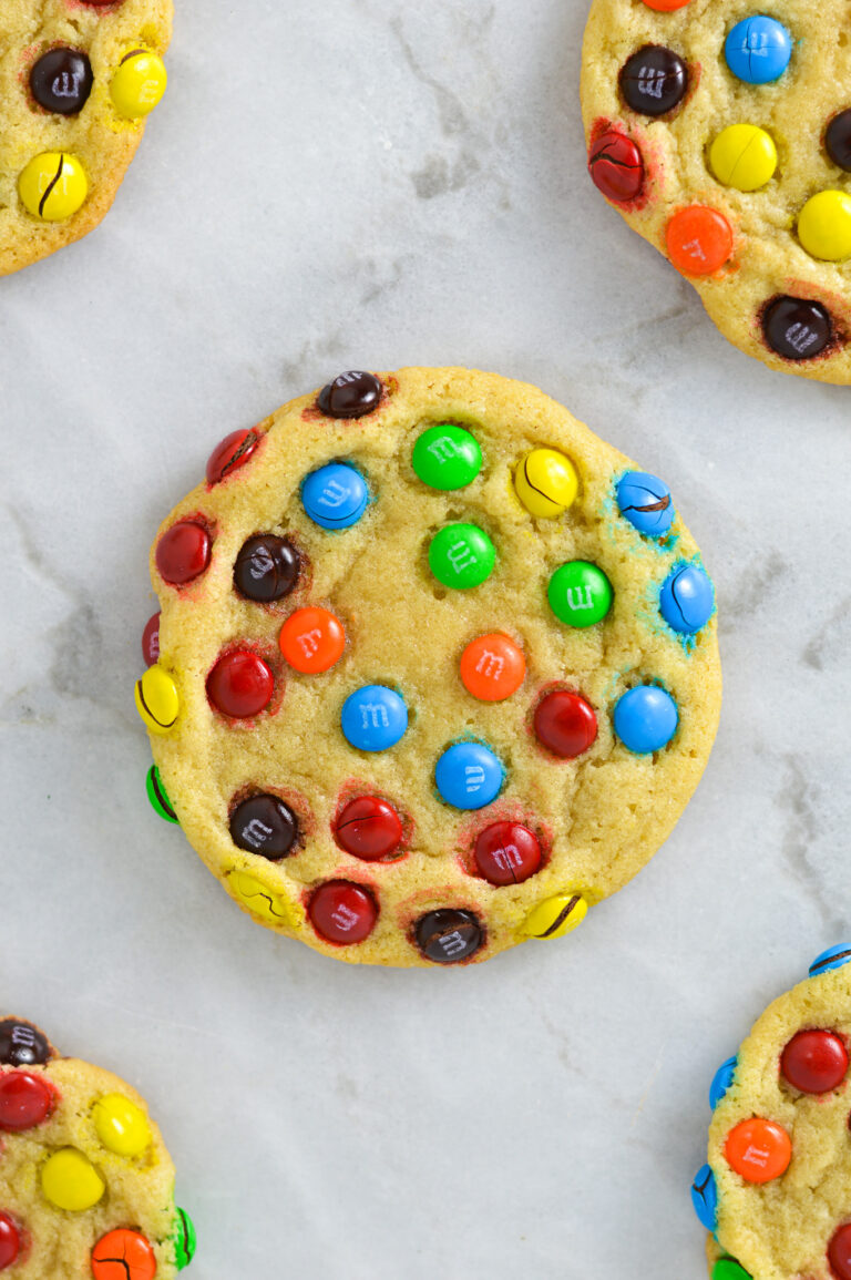 Some Mini M&M Cookies on a granite surface.