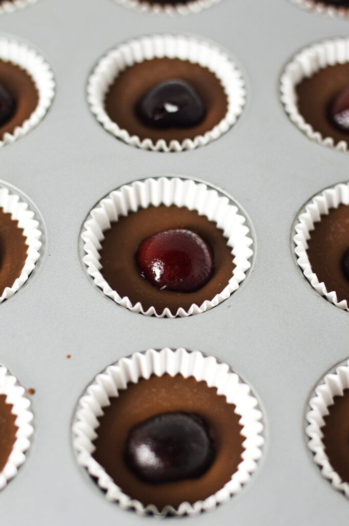 A mini muffin tin filled with Cherry Nutella Cups in mini cupcake liners.