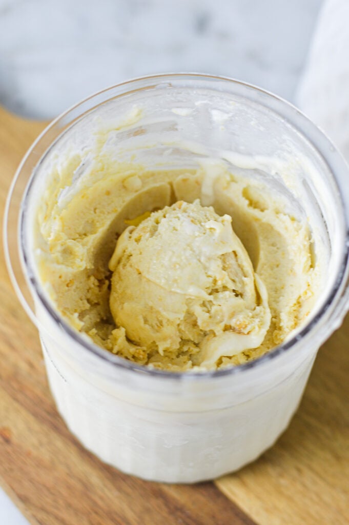 A Ninja Creami container filled with Ninja Creami Golden Oreo Ice Cream.