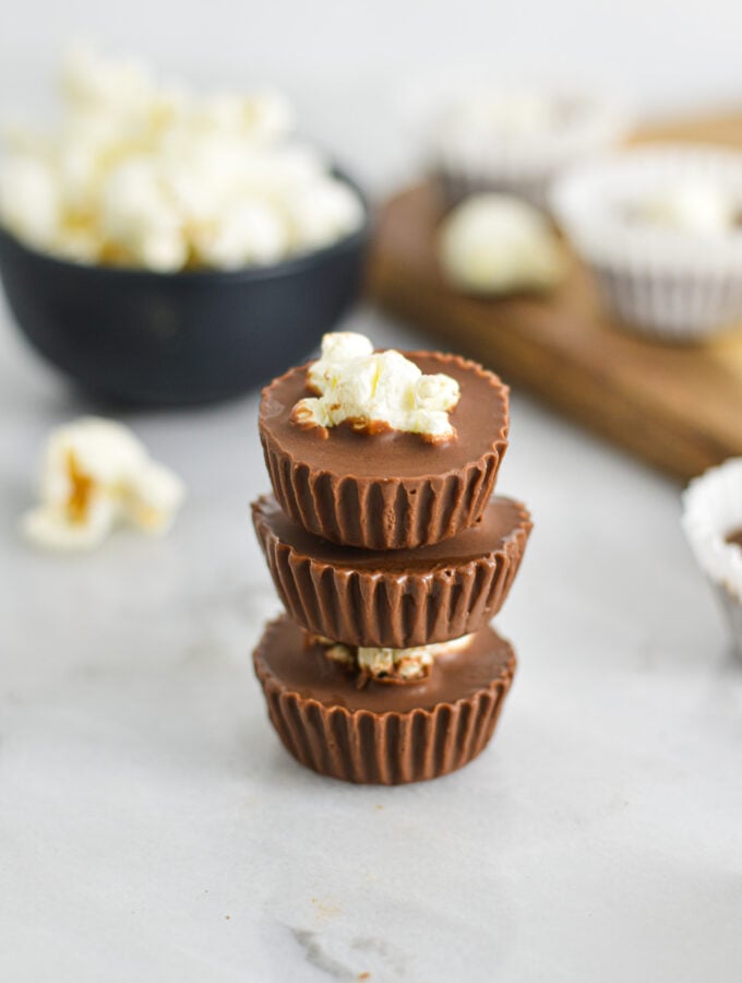 A stack of Popcorn Nutella Cups with the paper liners taken off to show the creamy texture.