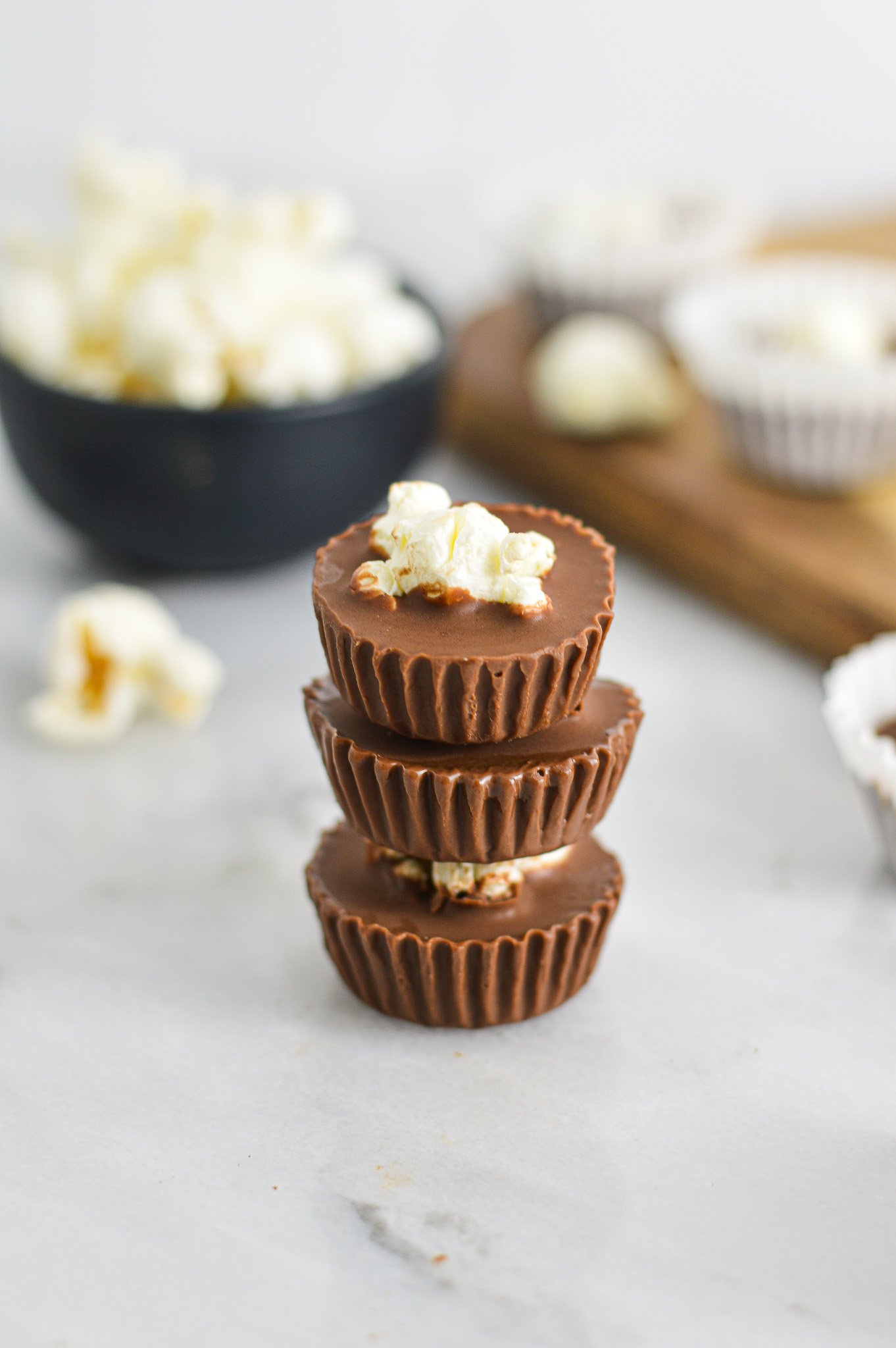 A stack of Popcorn Nutella Cups with the paper liners taken off to show the creamy texture.