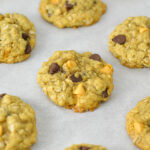 Homemade Oatmeal Butterscotch Chocolate Chip Cookies on a parchment paper lined cookie sheet.