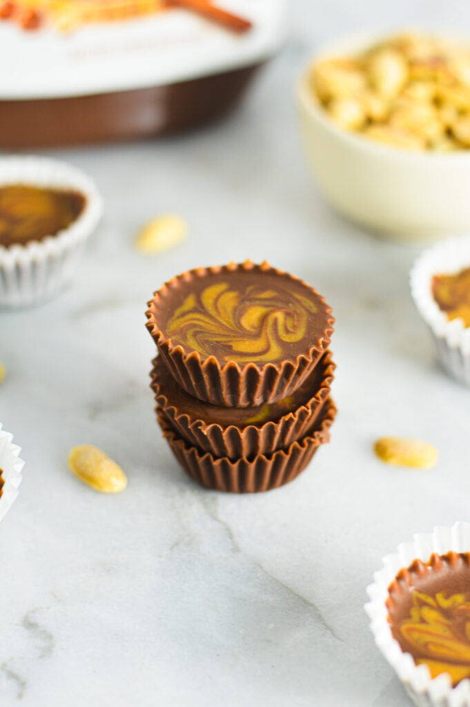 A stack of Peanut Butter Swirl Nutella Cups, with a peanut butter swirl on top contrasting the creamy Nutella base.