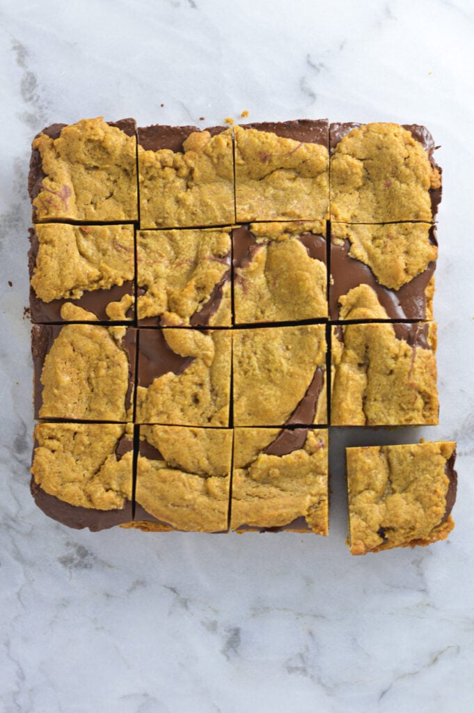 Homemade Pumpkin Nutella Bars on a granite surface, with the swirls of chocolate visible in the pumpkin base.