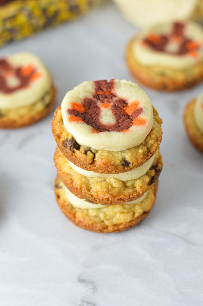 A stack of Thanksgiving Chocolate Chip Sugar Cookie Cups on a granite surface.