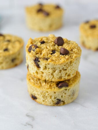 A stack of Chocolate Chip Baked Oatmeal Cups, with the rich chocolate chips sticking out of the nutritious oatmeal cups.