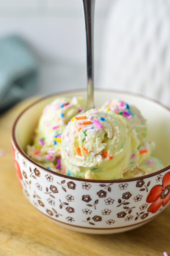 Ninja Creami Birthday Cake Ice Cream in a small bowl, with rainbow sprinkles on top.
