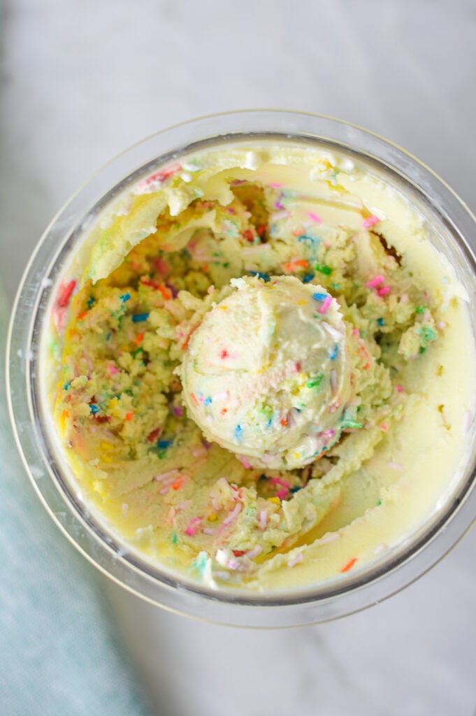A Ninja Creami pint container filled with Ninja Creami Birthday Cake Ice Cream.
