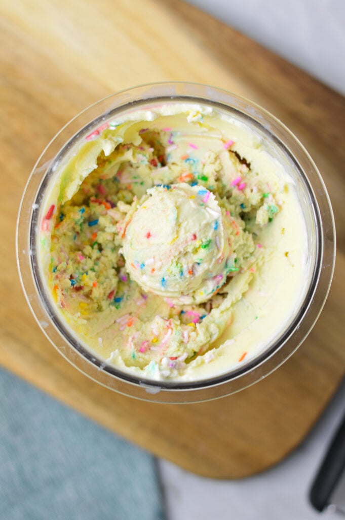 A Ninja Creami container filled with Ninja Creami Birthday Cake Ice Cream.