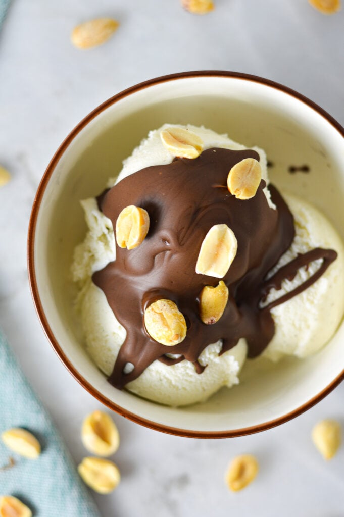 Rich Chocolate Peanut Butter Magic Shell, with dry roasted peanuts on top of the melted chocolate drizzled on vanilla ice cream.