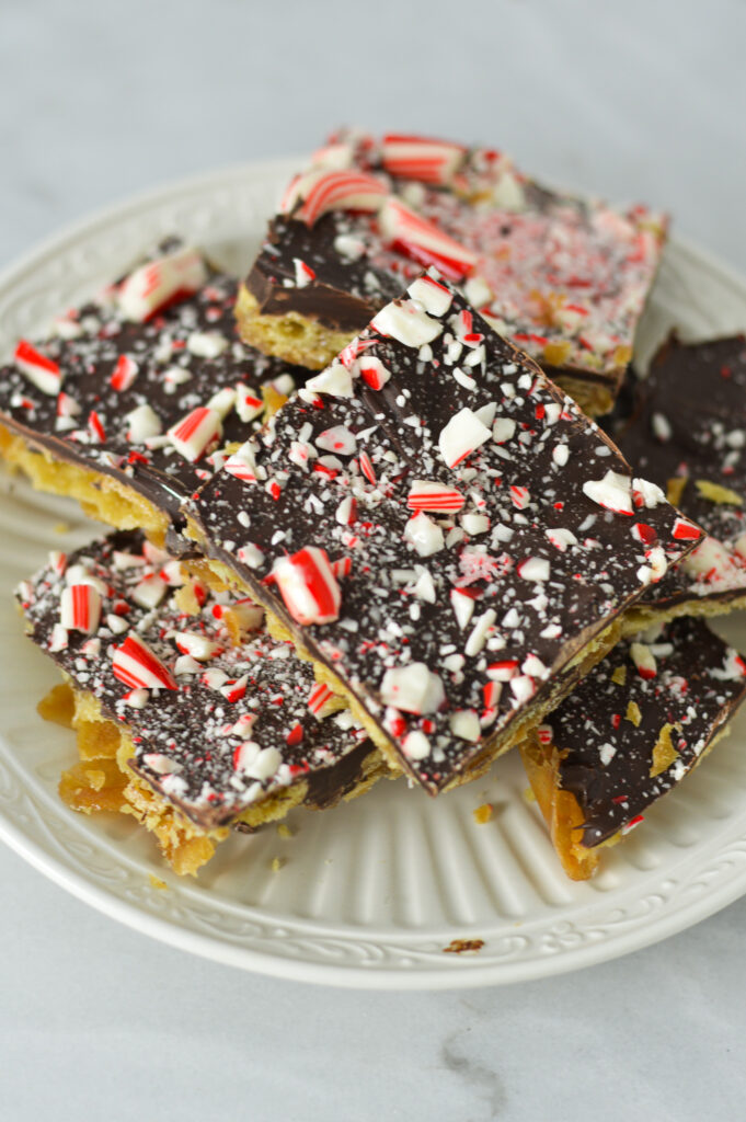 A plate full of semi sweet chocolate Candy Cane Saltine Toffee.