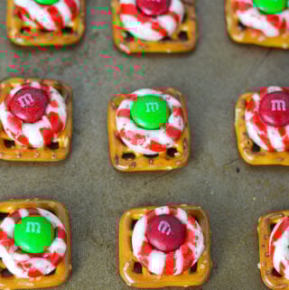 Some freshly baked Peppermint Kiss Pretzels on top of a baking sheet.