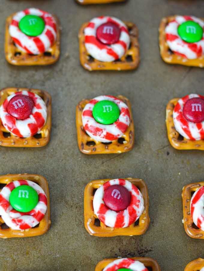 Some freshly baked Peppermint Kiss Pretzels on top of a baking sheet.