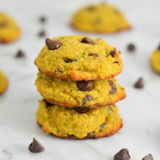 A stack of Coconut Flour Chocolate Chip Cookies, with the melty chocolate chips showing at the top of the soft cookies.