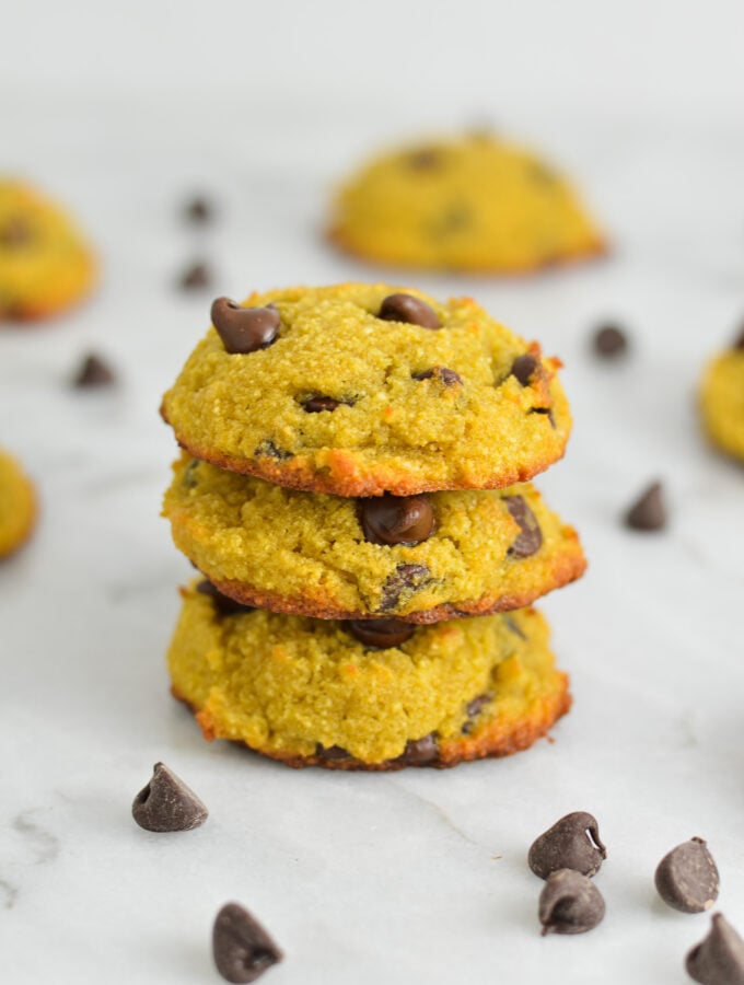 A stack of Coconut Flour Chocolate Chip Cookies, with the melty chocolate chips showing at the top of the soft cookies.