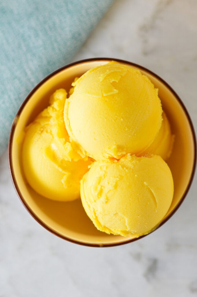 A small bowl filled with scoops of Ninja Creami Peach Sorbet.