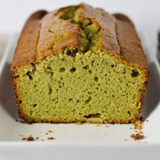 A cut loaf of Matcha Pound Cake, with a golden top and a vibrant green color on the inside.