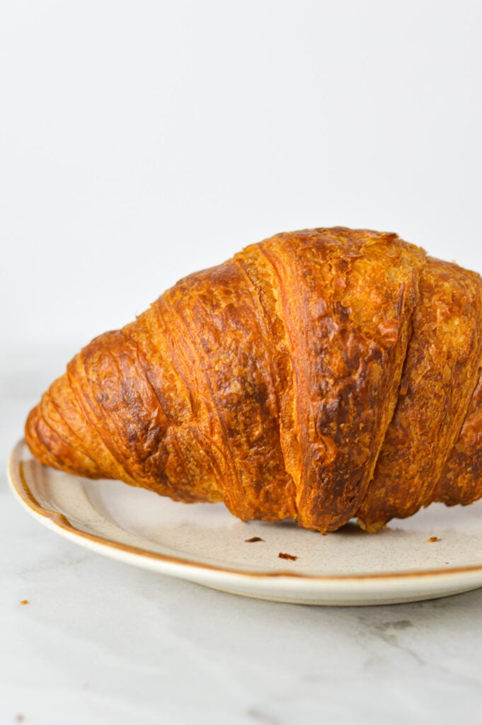 A closeup of a golden brown Air Fryer Croissant, made using Costco's croissants.
