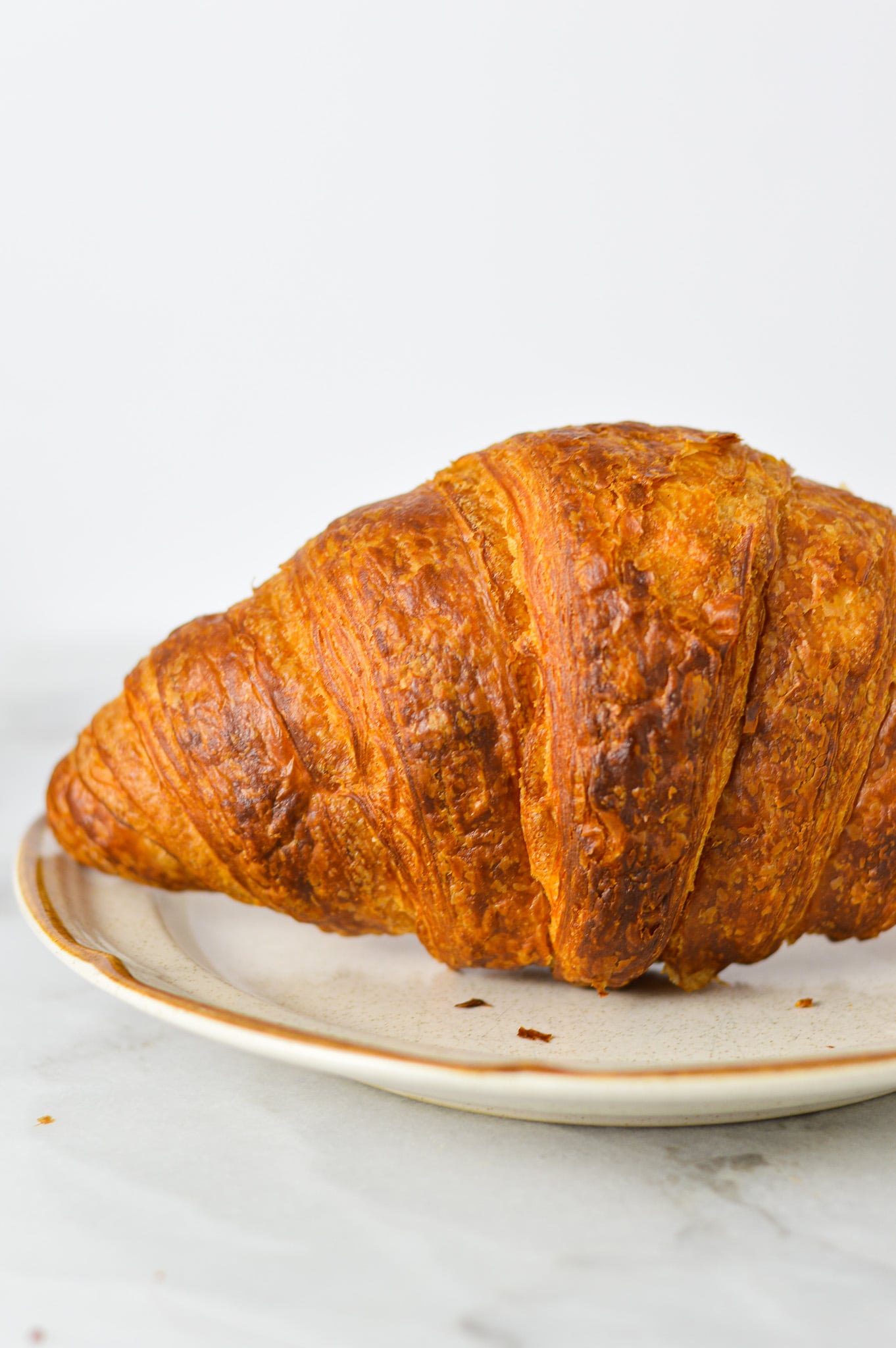 A closeup of a golden brown Air Fryer Croissant, made using Costco's croissants.