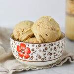 A bowl full of creamy Ninja Creami Cinnamon Protein Ice Cream, with the scoops showing its smooth texture.