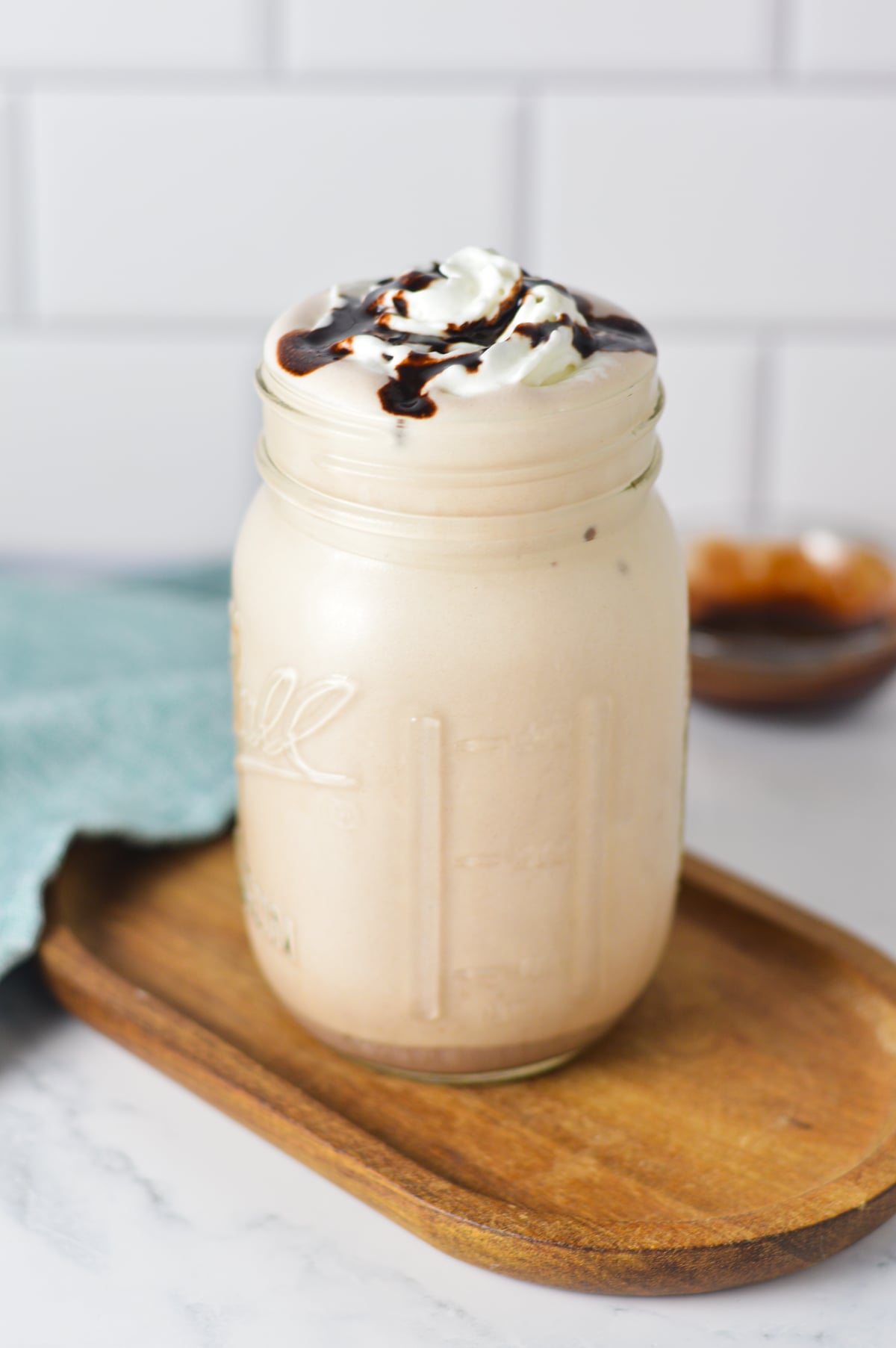 A finished 2-ingredient chocolate milkshake made in the Ninja Slushi machine, served in a glass jar.