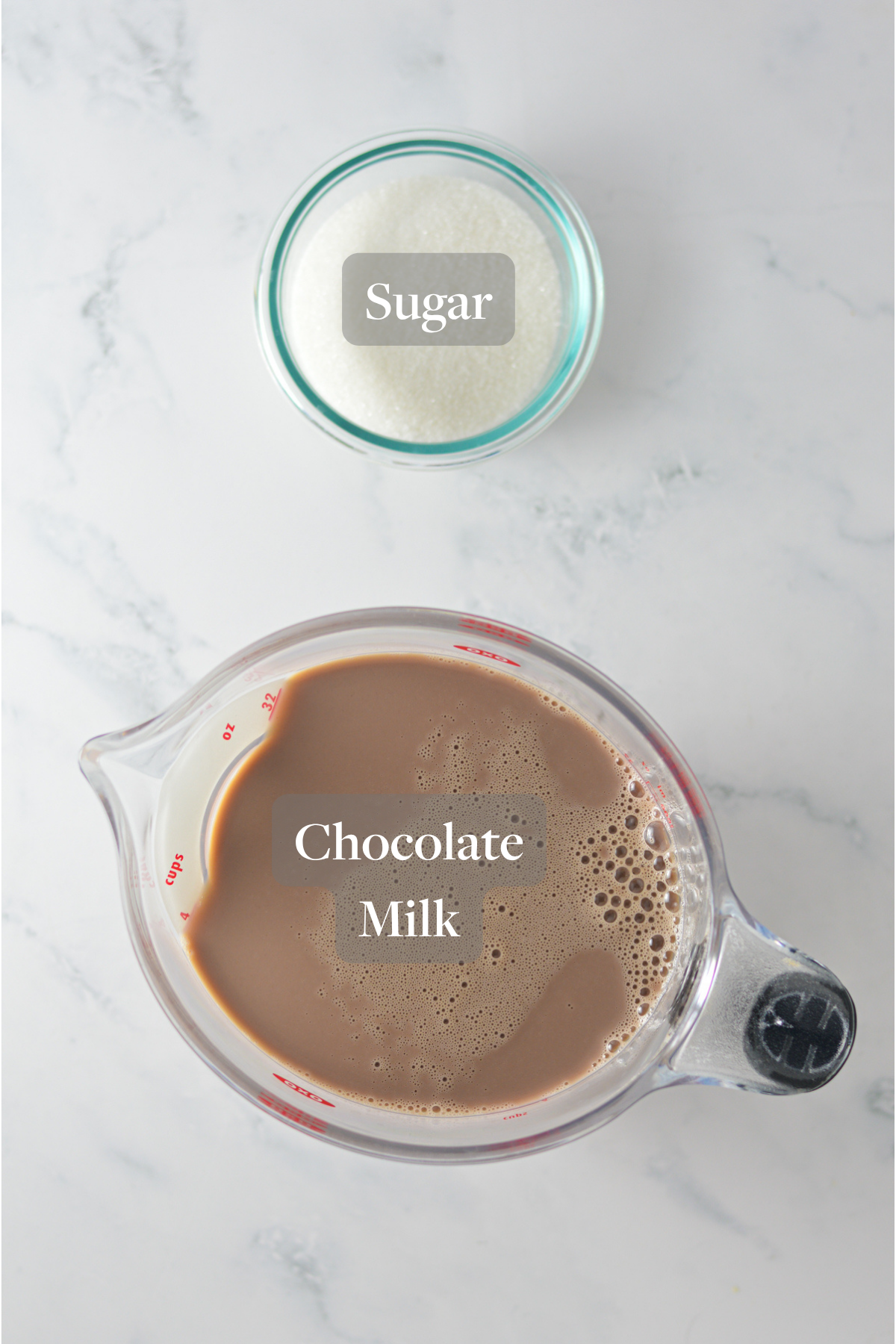 All the ingredients you need to make the Chocolate Ninja Slushi Milkshake laid out on a marble surface.