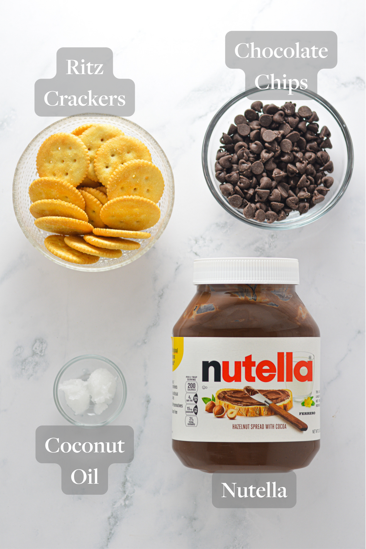 All the ingredients needed to make Chocolate Covered Nutella Ritz laid out on a marble surface.